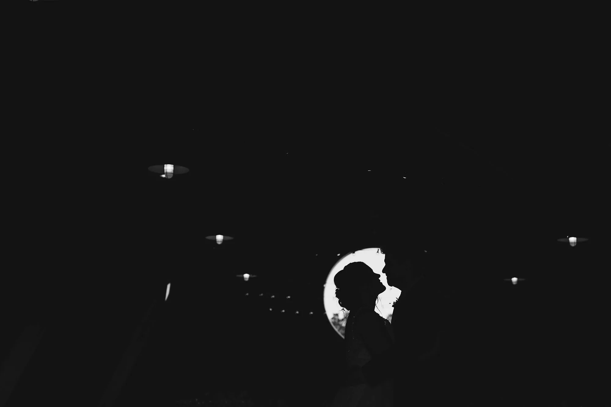 A documentary photograph featured in the best of wedding photography of 2019 showing a bride and groom sharing an intimate moment during their wedding reception