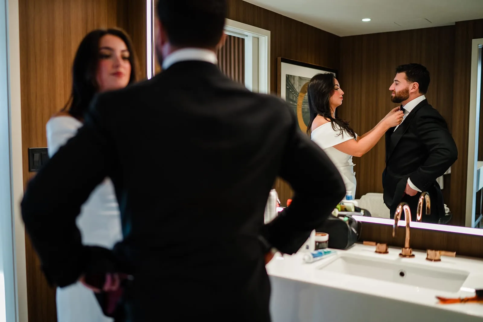 A documentary photograph of a bride and groom getting ready together at Omni Seaport before their Boston City Hall ceremony and intimate wedding at Mooo.... Seaport.