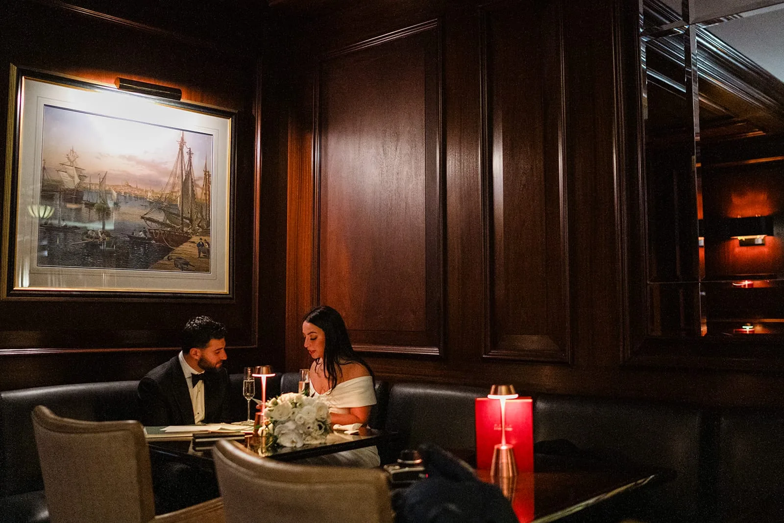 A documentary photograph of a bride and groom reading private vows at The Dark Bar before their intimate wedding at Mooo.... Seaport.