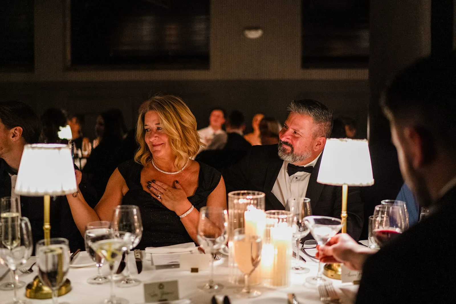 A documentary photograph of the groom's parents reacting to the toasts during their son's wedding celebration at Mooo.... Seaport.