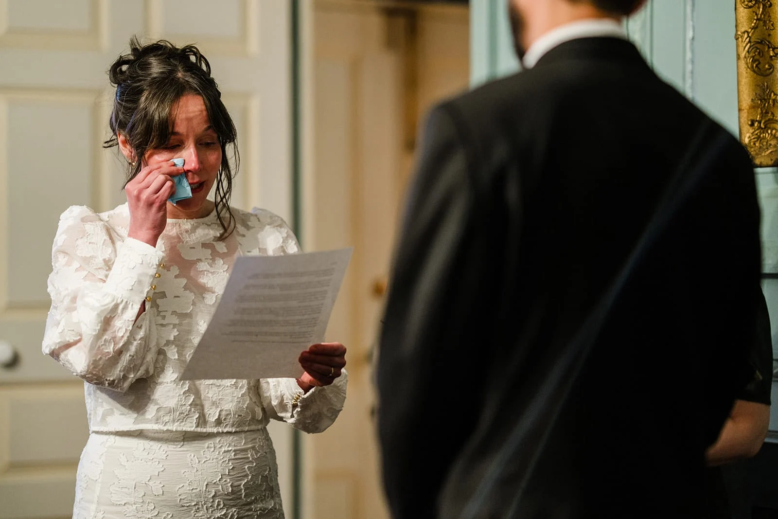 A documentary photograph of bride tearing up while saying her vows during their Loring Greenough House Wedding ceremony.