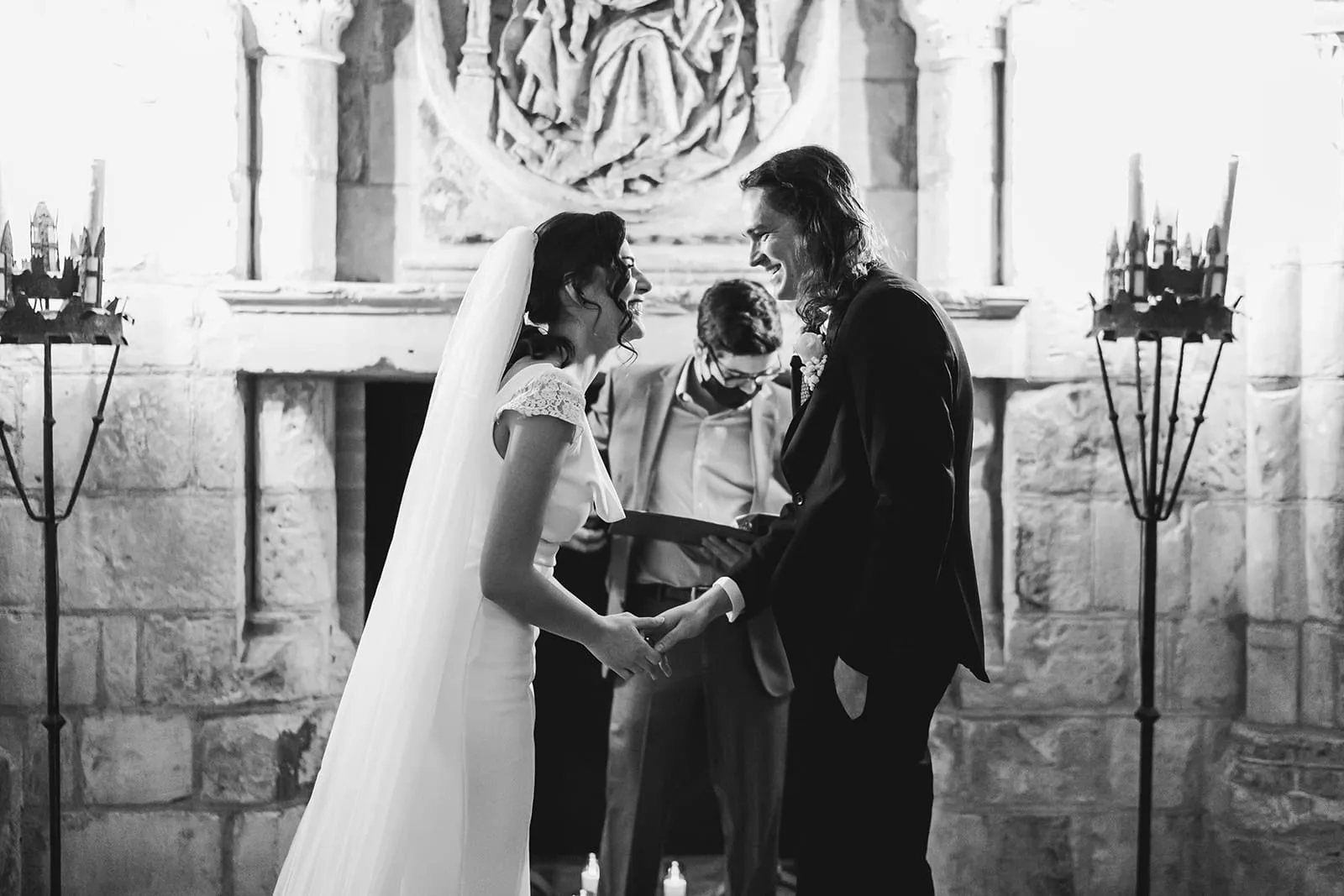 A documentary photograph of a bride and groom smiling at the top of the aisle during their intimate Worcester Art Museum Wedding Ceremony