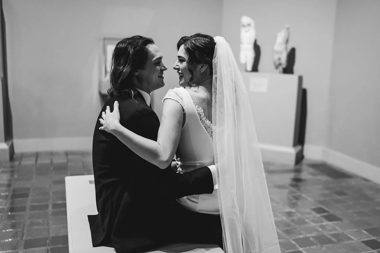 A documentary photograph of a bride and groom spending time in the art galleries during their intimate Worcester Art Museum Wedding