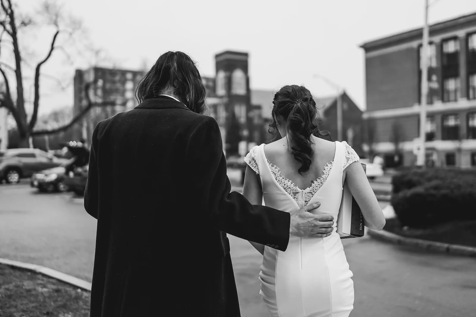 A documentary photograph of a bride and groom heading outside  during their intimate Worcester Art Museum Wedding