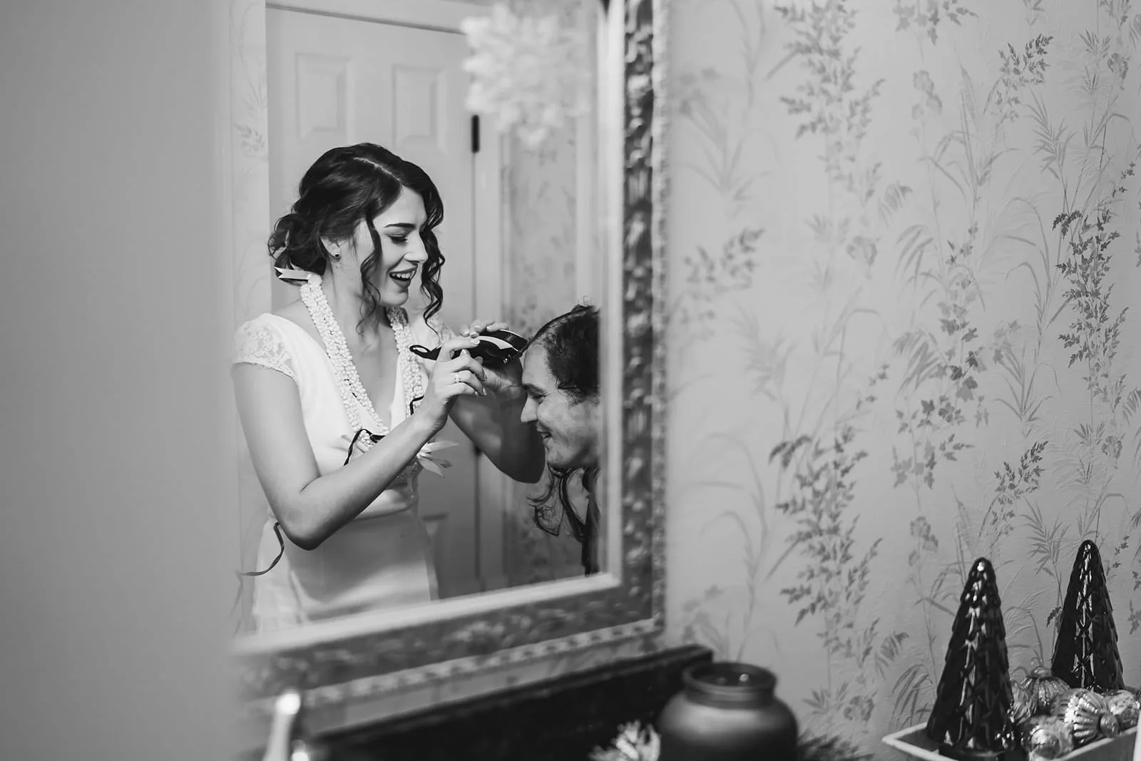 A documentary photograph of a bride shaving a groom's head before cancer treatment during a in home celebration after their intimate Worcester Art Museum Wedding ceremony