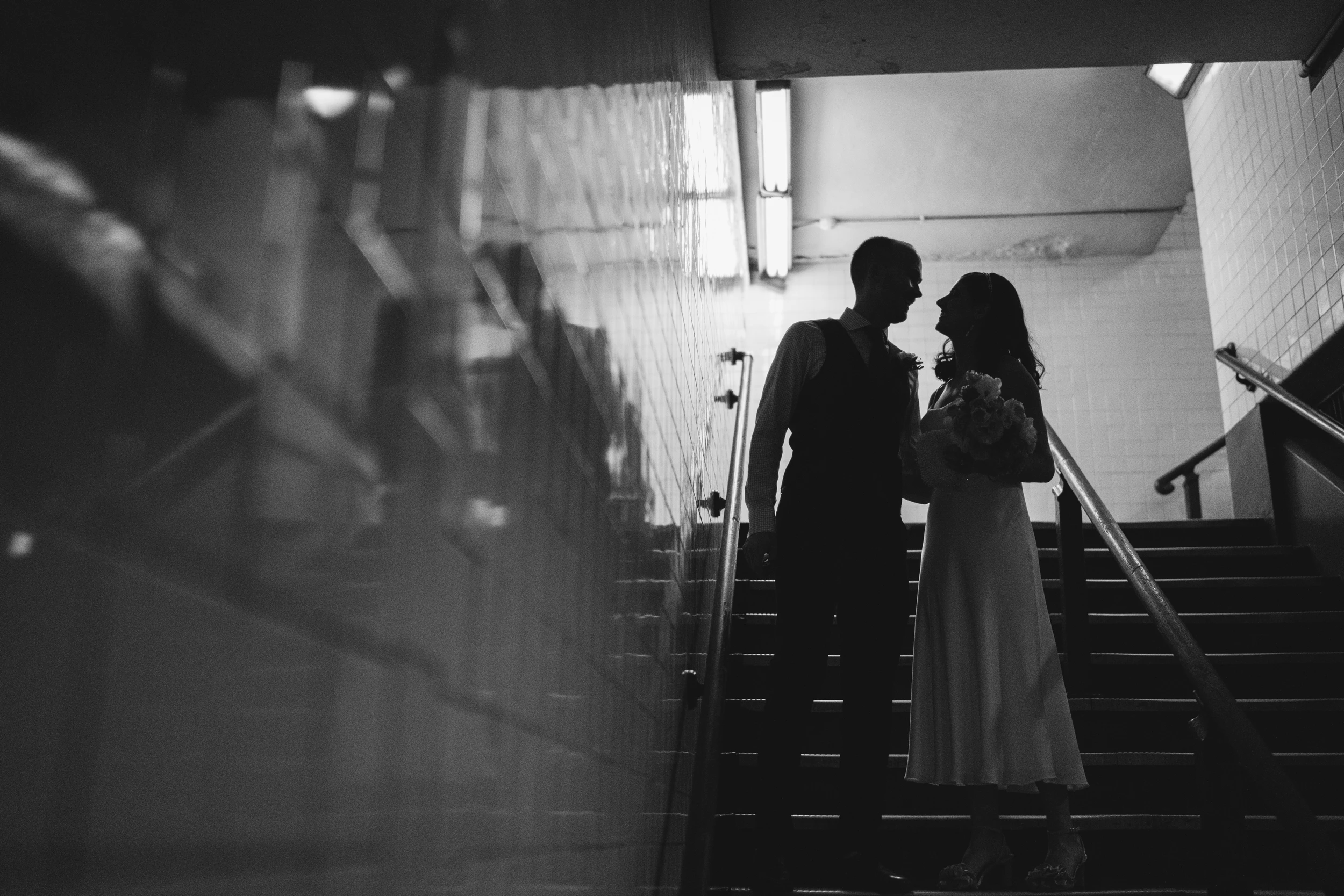The couple as silhouettes at the top of a staircase
