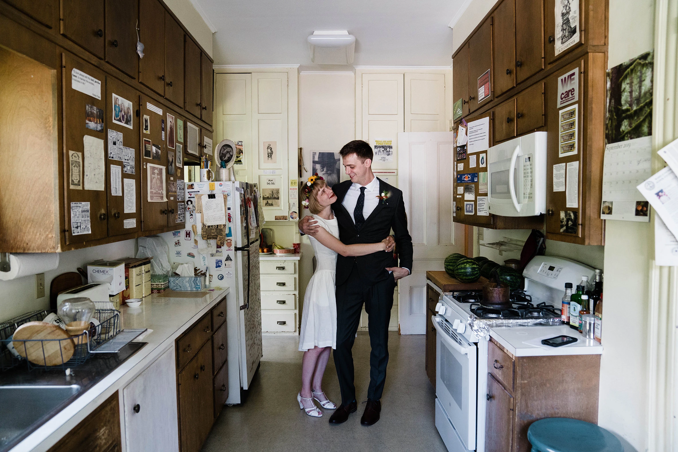The couple standing together in a home kitchen