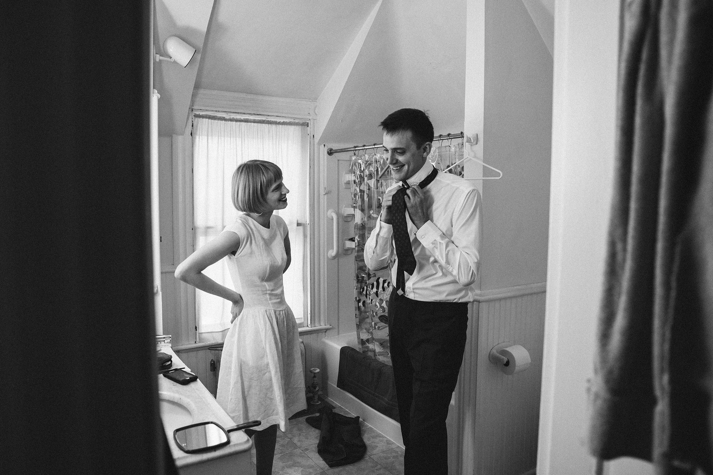 The couple dressing in a bright attic room