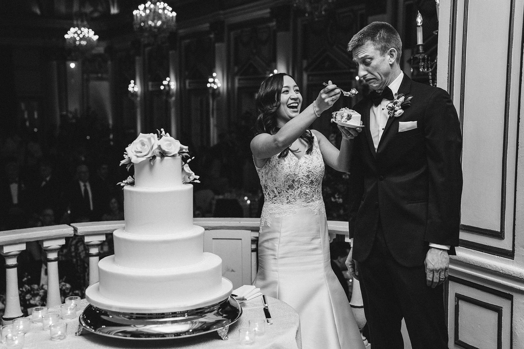 The couple cutting a tiered cake