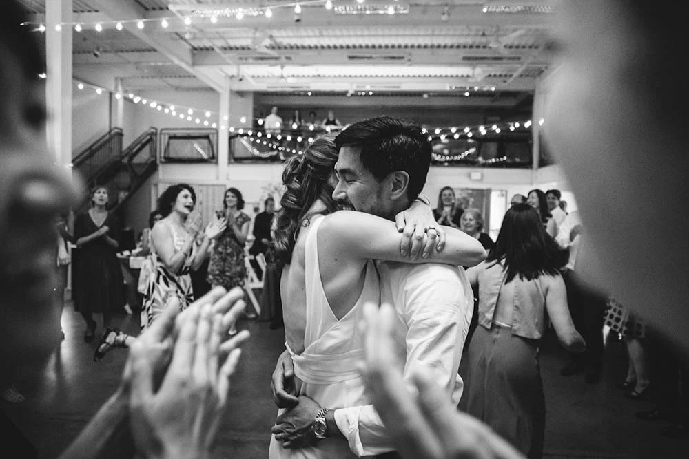 A couple embracing on a crowded dance floor
