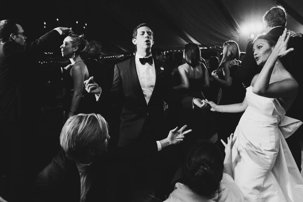 The couple dancing among guests