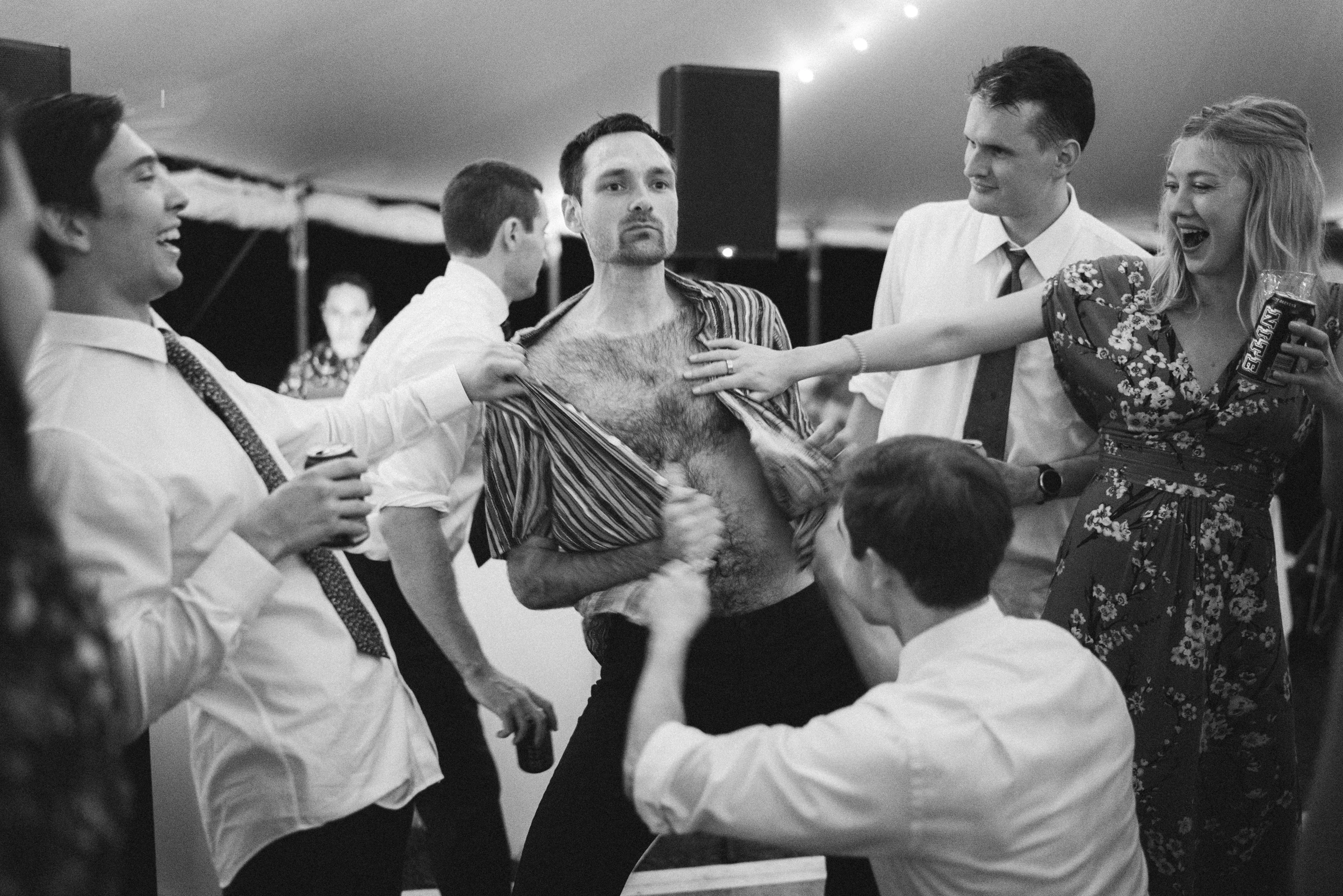 Friends shouting and dancing under the tent